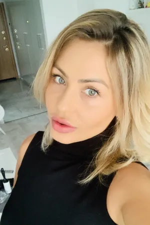 Olivia taking a selfie in a black top