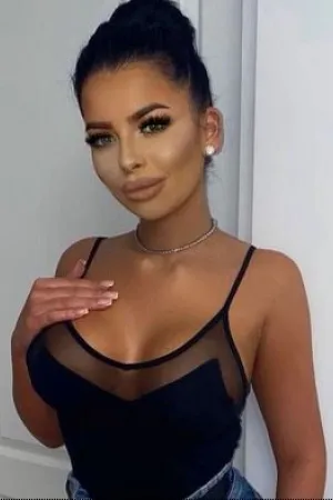 Amelia showing you her upper chest in a tank top